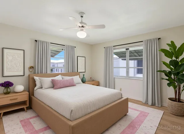 a bedroom with a large bed and a potted plant