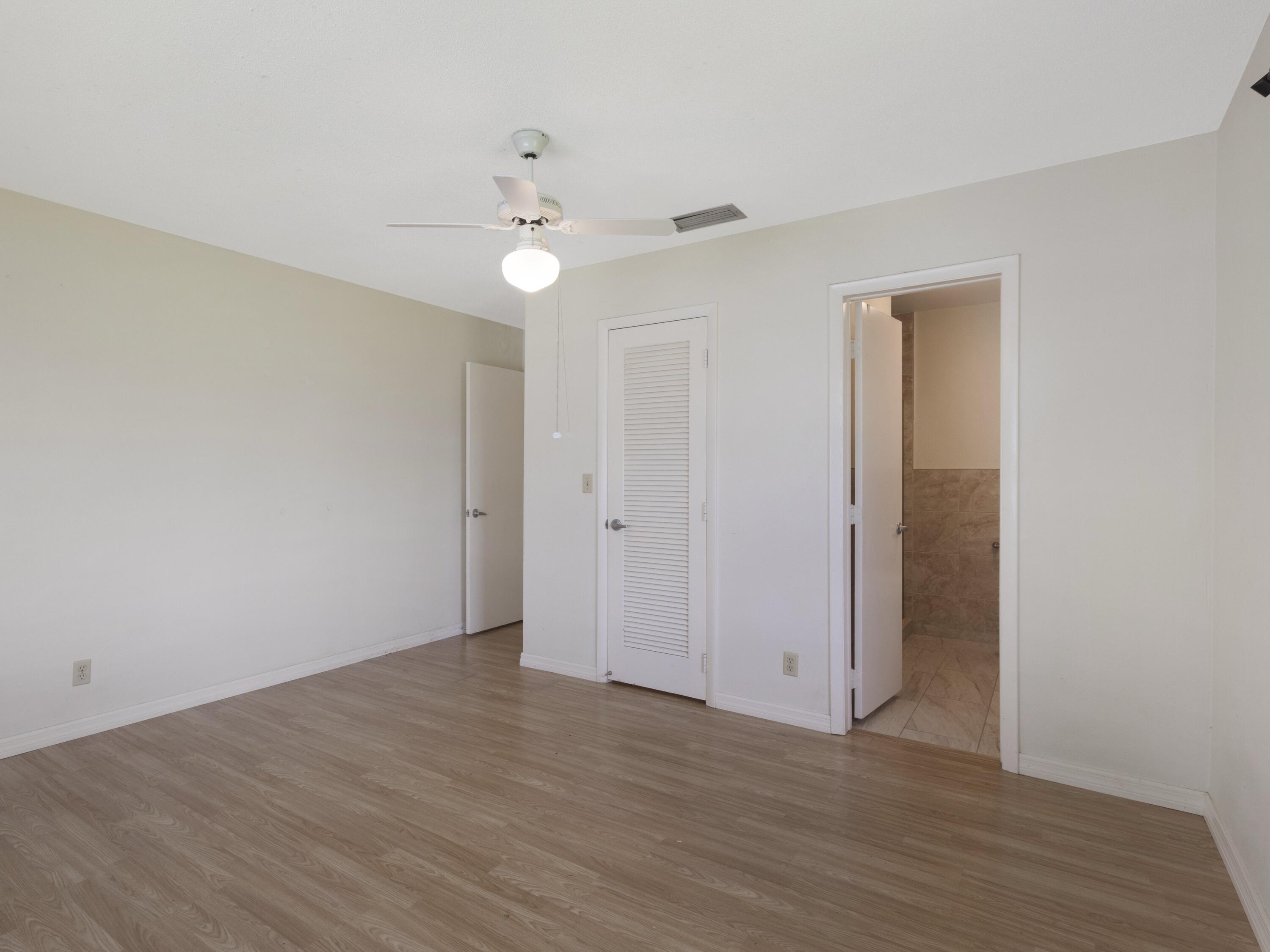 127 Leisureville Boulevard Boynton Beach, FL 33426 - Photo 14 of 23 a view of an empty room with wooden floor