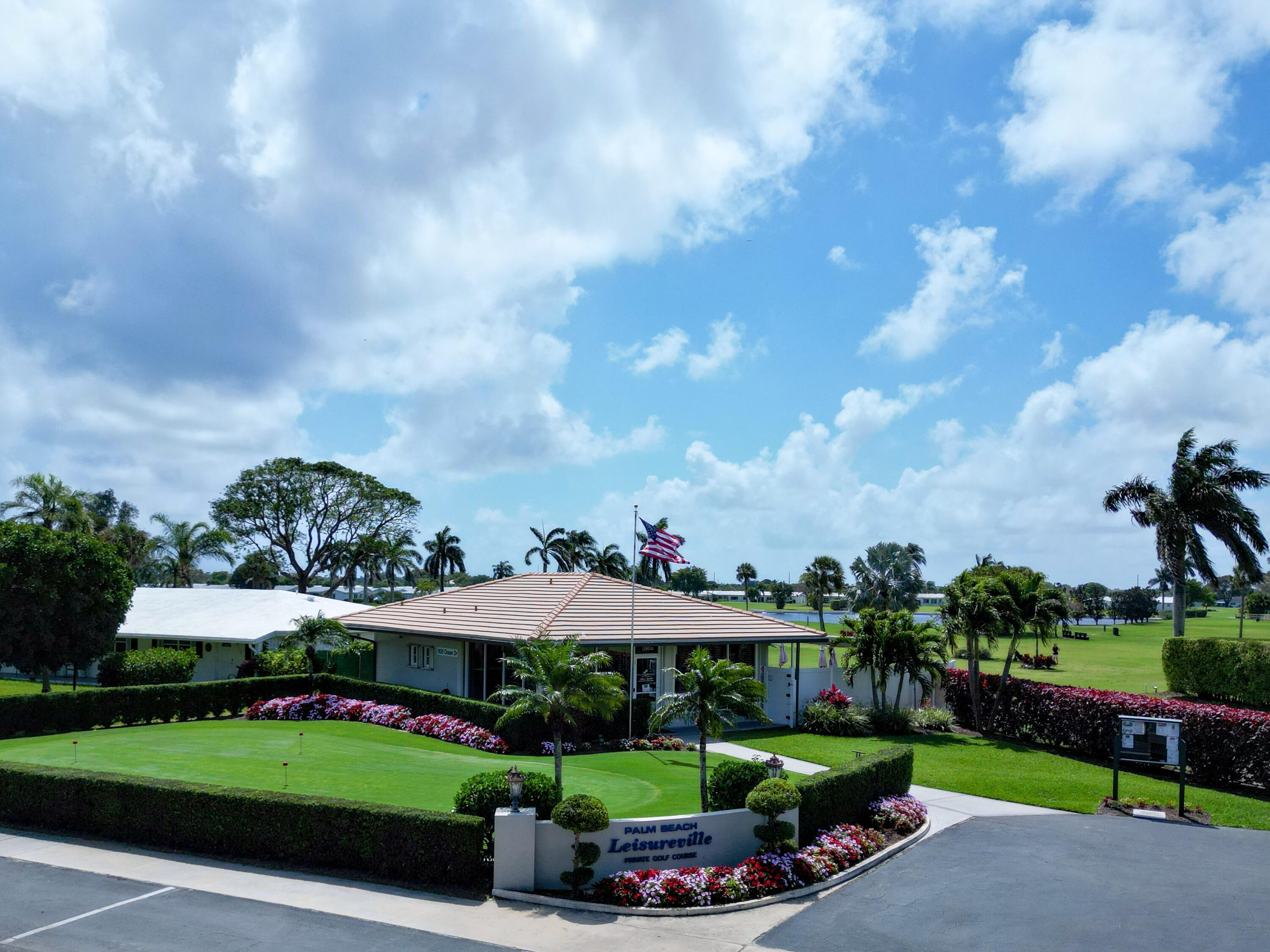 127 Leisureville Boulevard Boynton Beach, FL 33426 - Photo 22 of 23 a view of a garden with a lot of flower plants and wooden fence