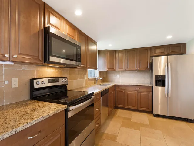 a kitchen with a refrigerator stove and microwave