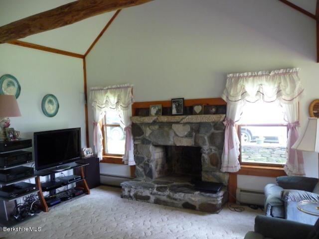 51 Madden Road Hancock, MA 01237 - Photo 11 of 19 a living room with furniture a flat screen tv and a fireplace