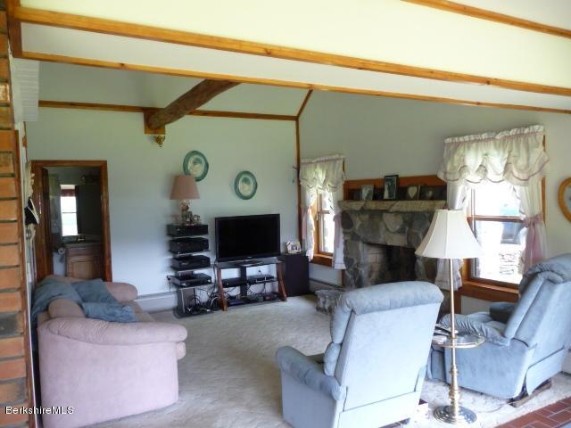 51 Madden Road Hancock, MA 01237 - Photo 9 of 19 a living room with furniture a flat screen tv and a fireplace
