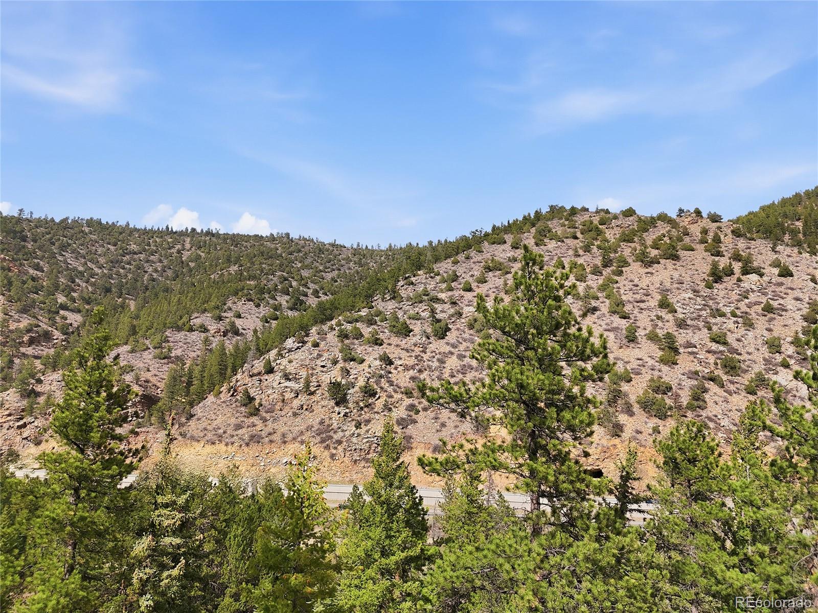 2238 Stanley Road Dumont, CO 80436 - Photo 17 of 20 a view of a large building with mountains in the background
