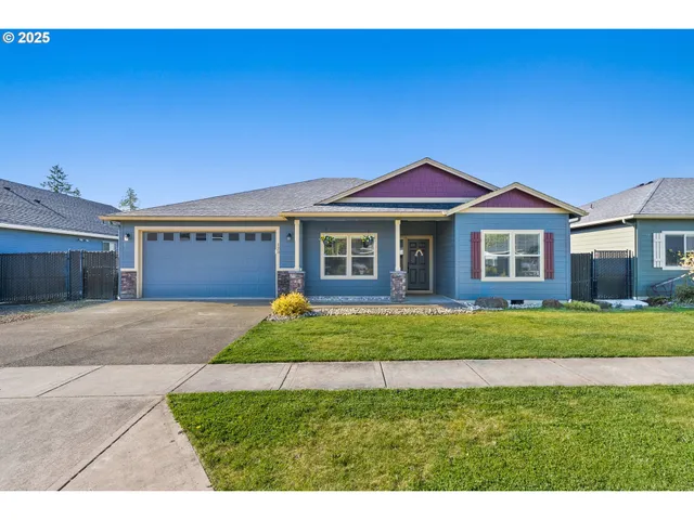 a front view of a house with a garden and yard