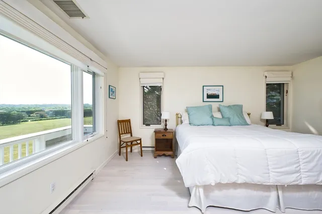 a spacious bedroom with a large bed and a large window