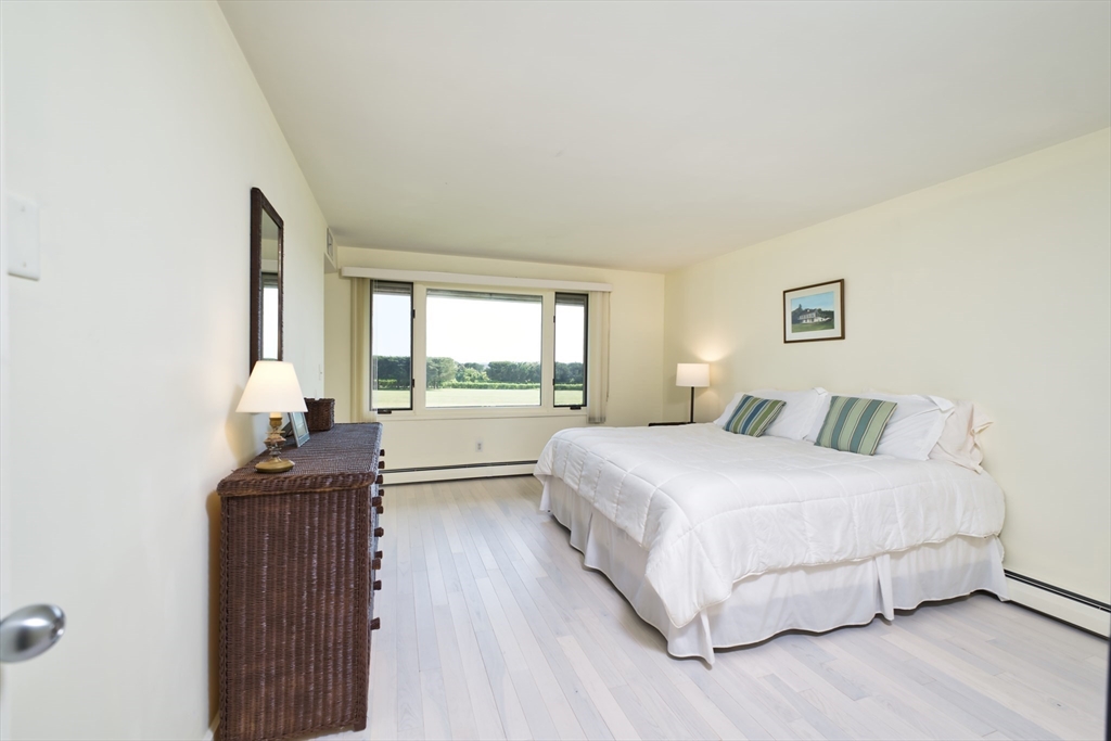 34 North Shore Drive, Unit 3 Dartmouth, MA 02748 - Photo 19 of 34 a bedroom with a bed and a dresser next to a window