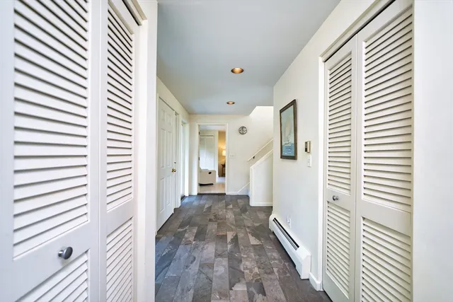 a view of a hallway with wooden floor and staircase