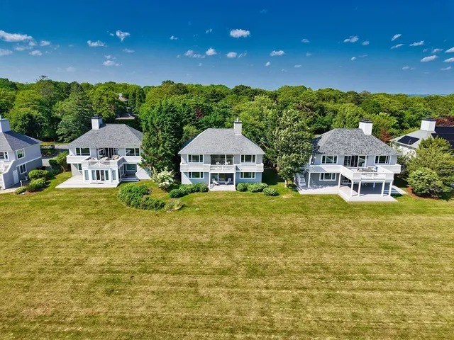 a front view of a house with yard and green space