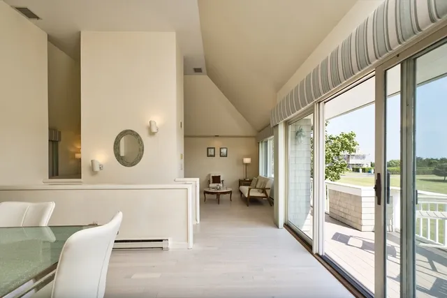 a living room with a large window and a table