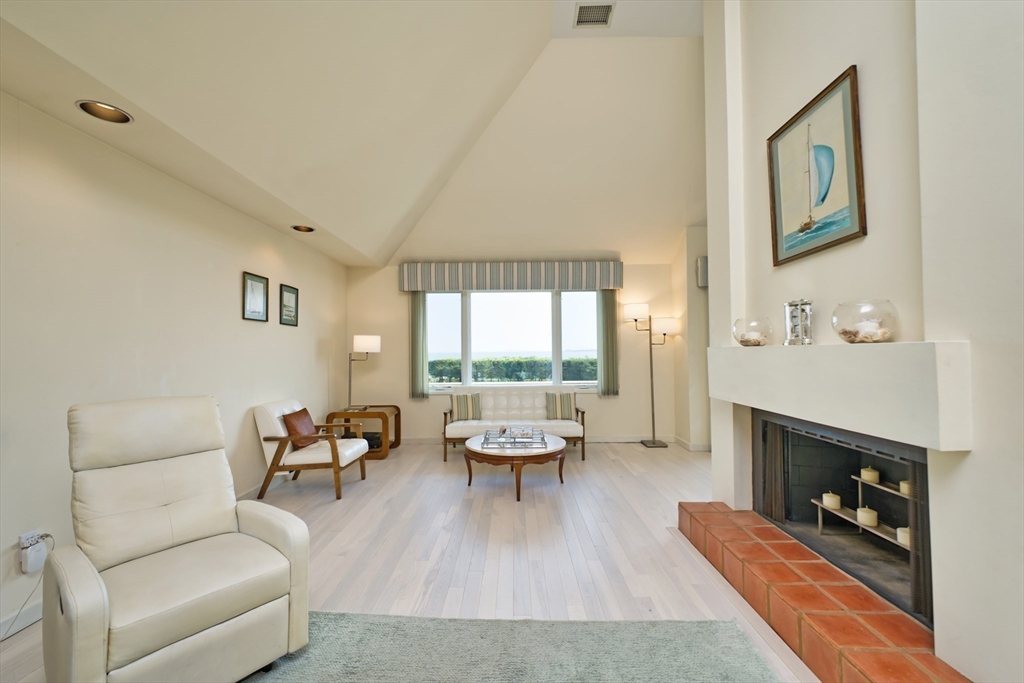 34 North Shore Drive, Unit 3 Dartmouth, MA 02748 - Photo 8 of 34 a living room with furniture and a fireplace