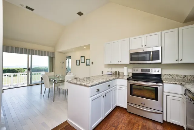 a kitchen with a stove a sink and a refrigerator