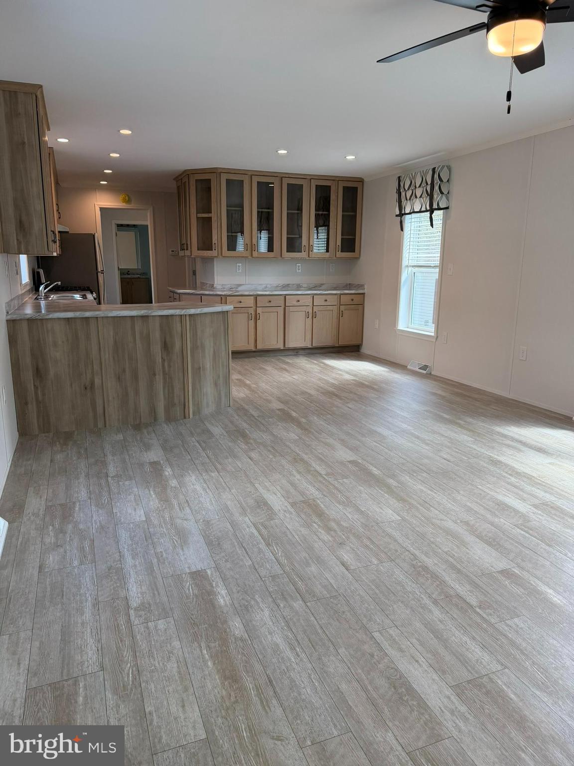 365 East Cherry Road Quakertown, PA 18951 - Photo 7 of 51 a view of kitchen with kitchen island a sink wooden floor and a large window