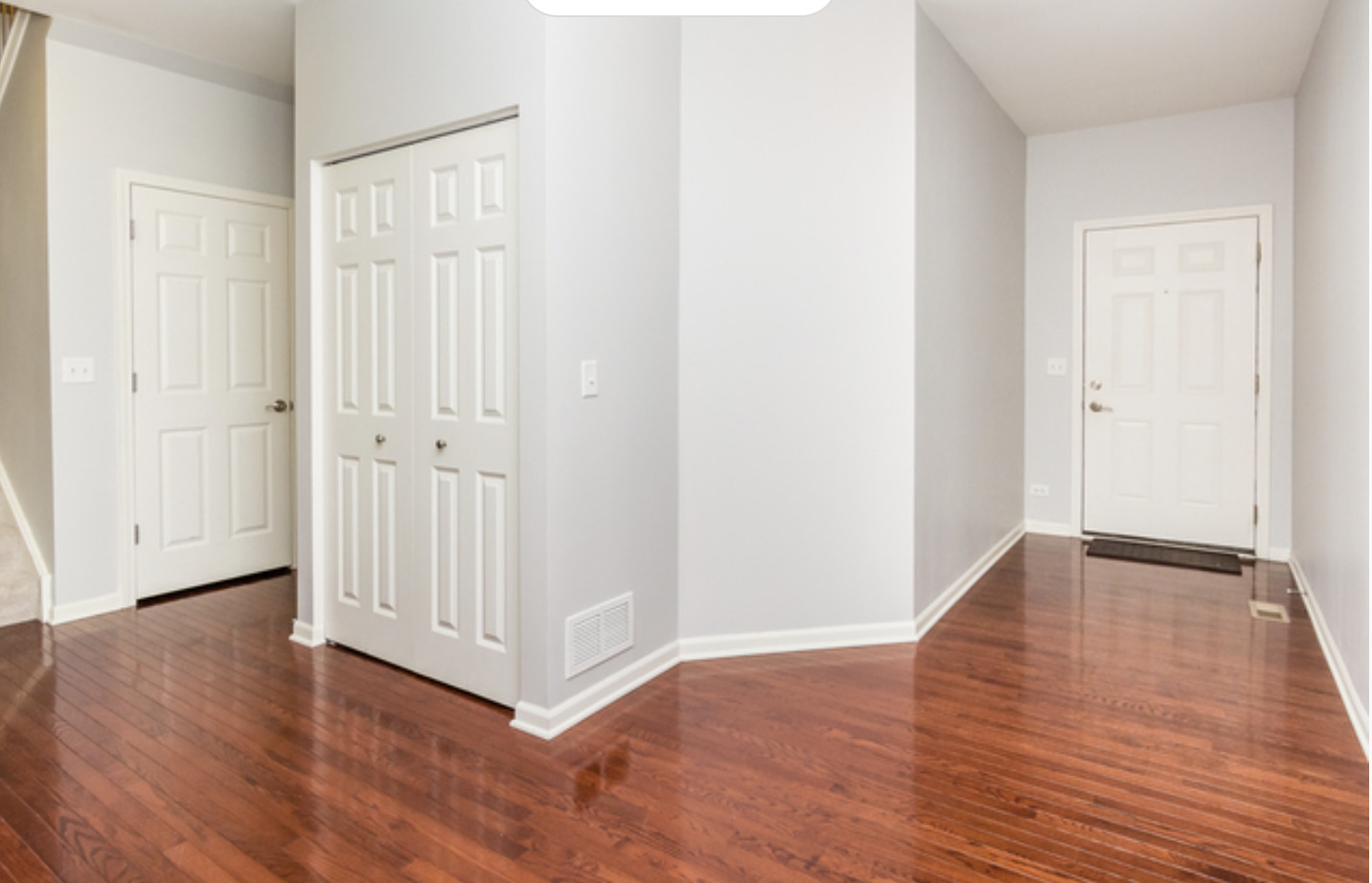 10-s449 Carrington Circle Burr Ridge, IL 60527 - Photo 3 of 21 a view of an empty room with wooden floor