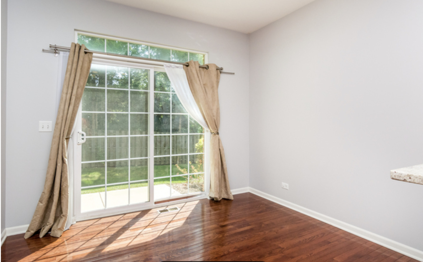 10-s449 Carrington Circle Burr Ridge, IL 60527 - Photo 6 of 21 a view of an empty room with wooden floor and a window