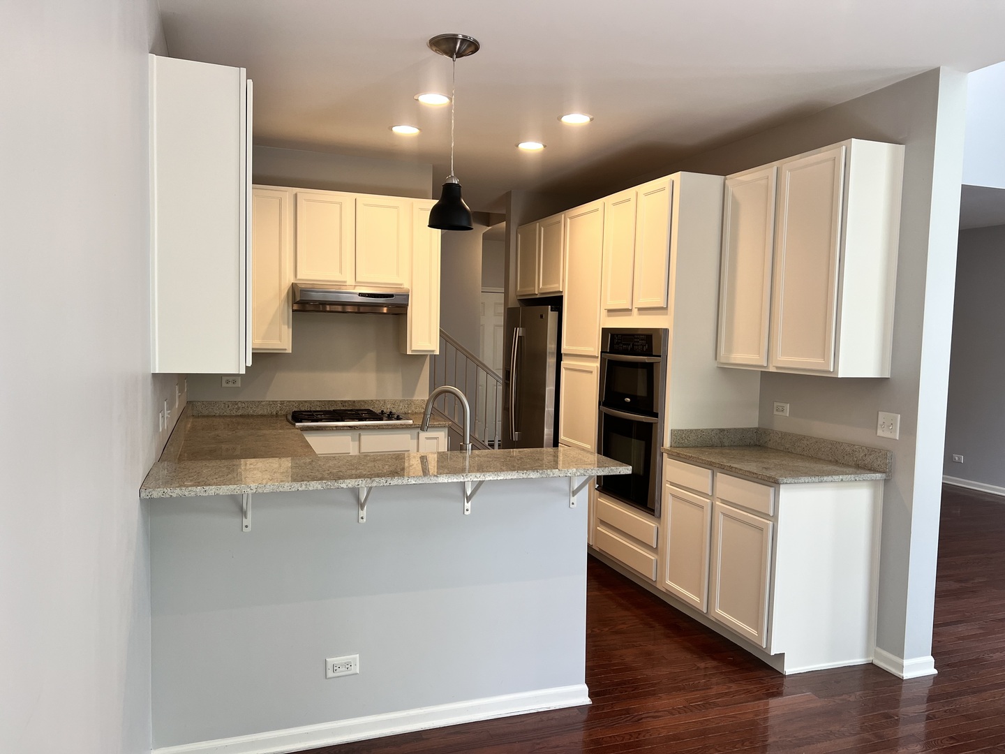 10-s449 Carrington Circle Burr Ridge, IL 60527 - Photo 7 of 21 a kitchen with kitchen island a stove a sink and a refrigerator with wooden floor