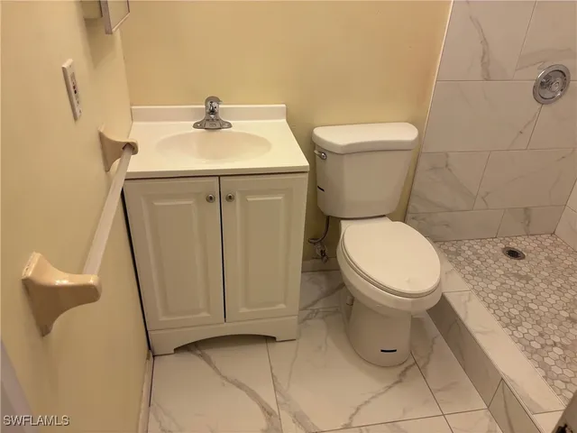a view of a hallway with wooden floor and door