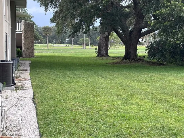 a view of a garden with a building in the background
