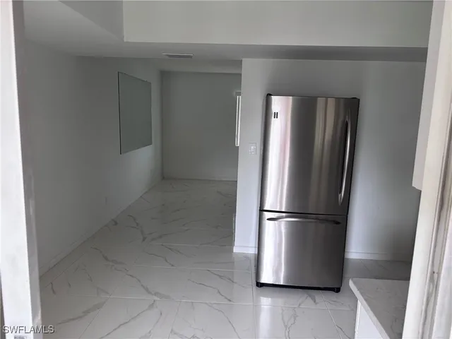 a kitchen with cabinets stainless steel appliances and a counter space