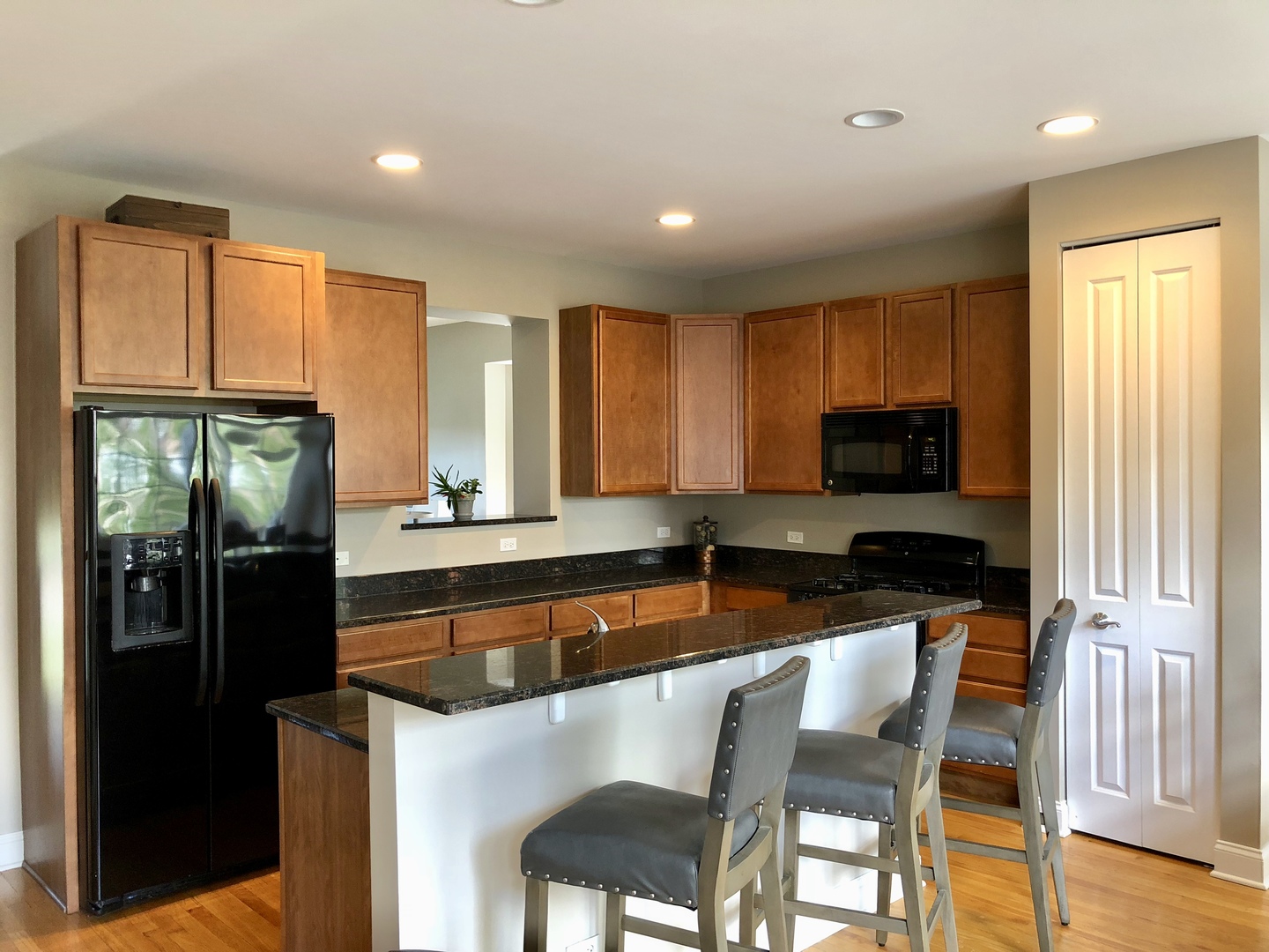S020 Kerry Court Winfield, IL 60190 - Photo 7 of 23 a kitchen with granite countertop kitchen island stainless steel appliances a refrigerator a stove a sink and a dining table