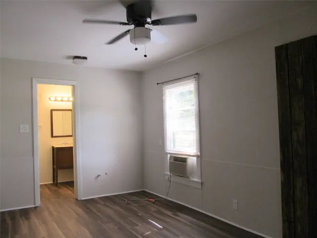 an empty room with windows and closet