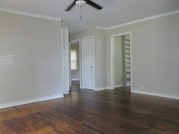 a view of an empty room with wooden floor