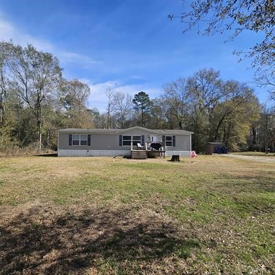 139 Malcom Street Ames, TX 77575 - Photo 1 of 26 a front view of a house with a yard