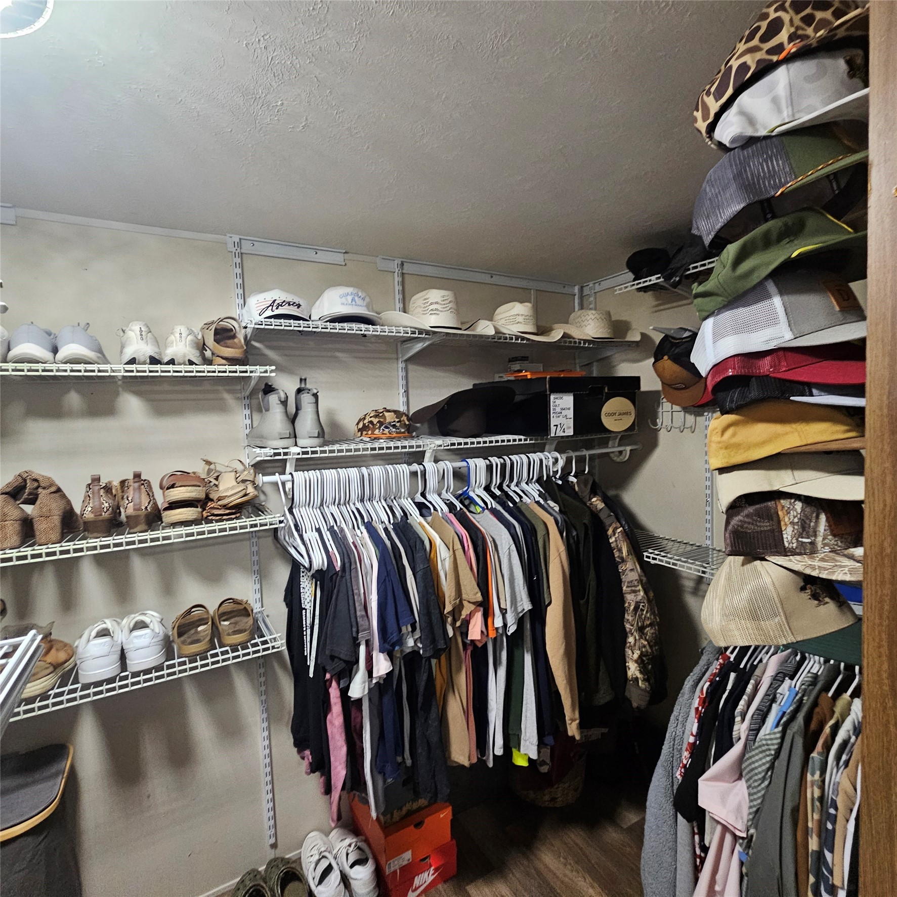 139 Malcom Street Ames, TX 77575 - Photo 12 of 26 a view of walk in closet with clothes and shoes