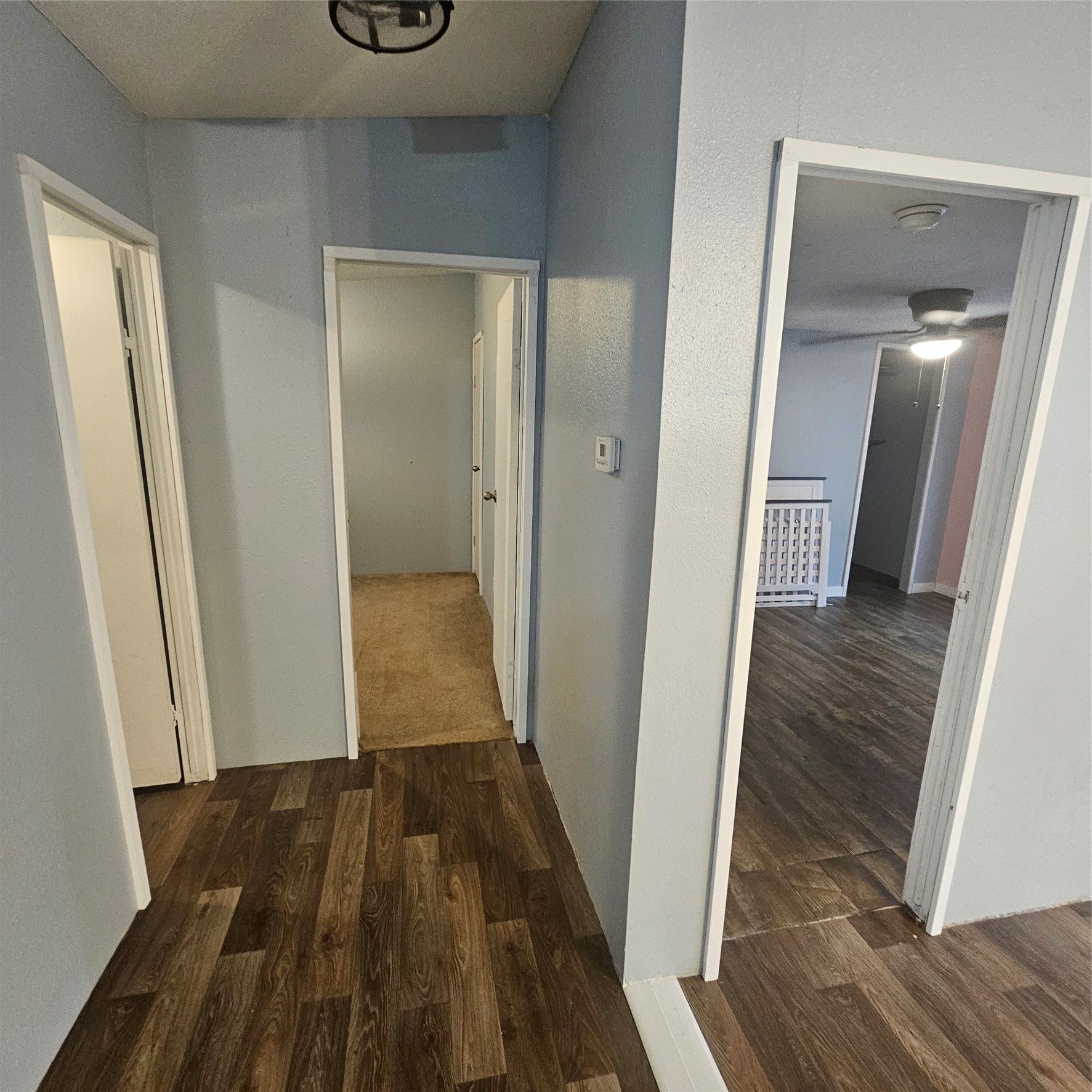 139 Malcom Street Ames, TX 77575 - Photo 20 of 26 a view of a hallway with wooden floor and staircase