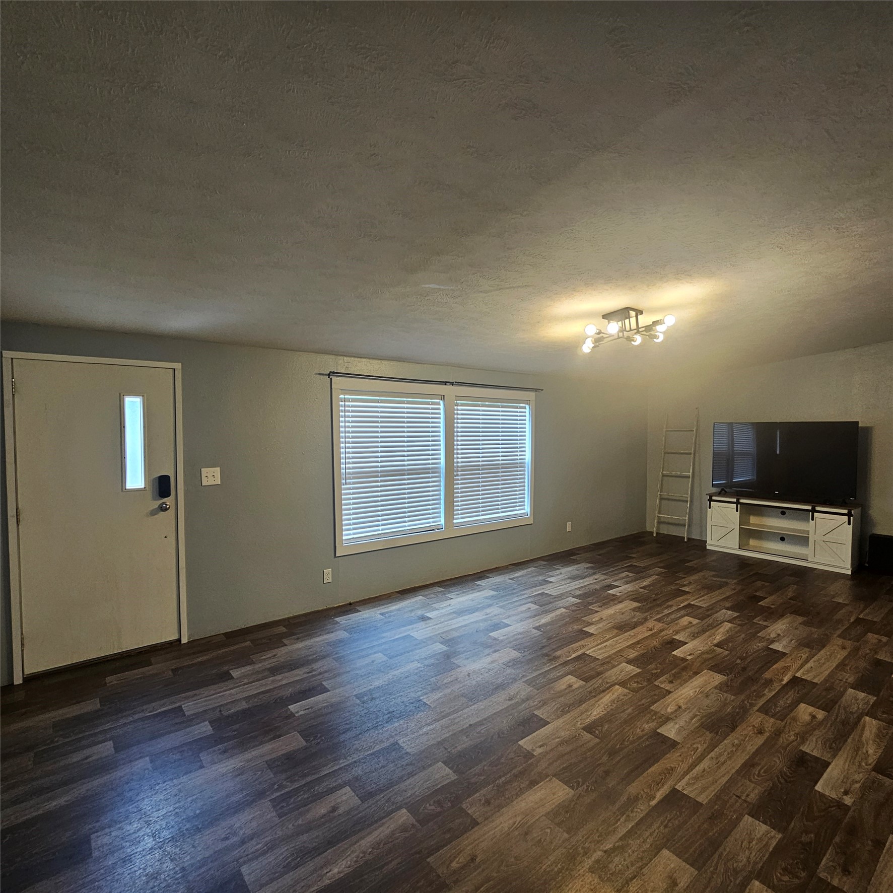 139 Malcom Street Ames, TX 77575 - Photo 22 of 26 a view of a livingroom with a flat screen tv