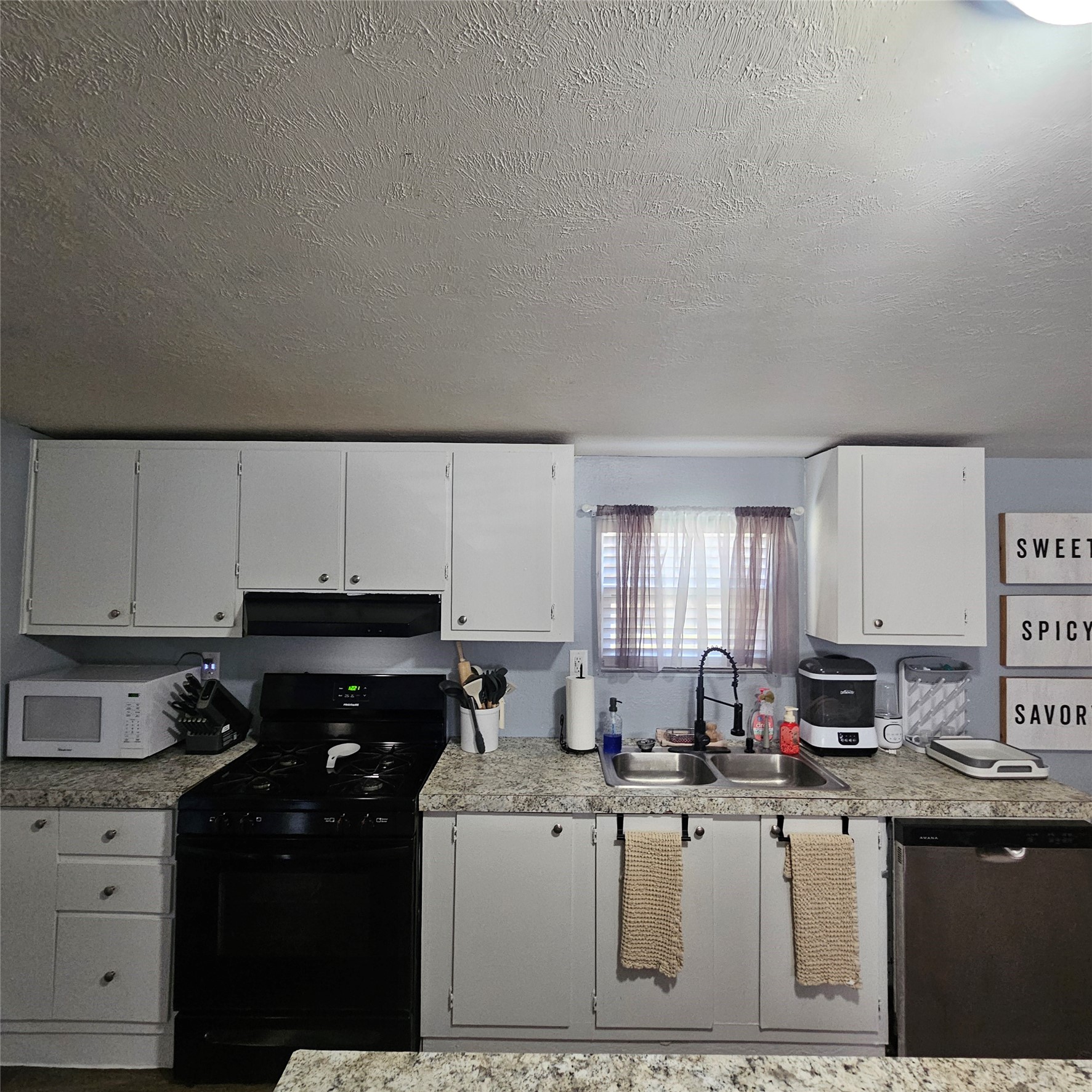 139 Malcom Street Ames, TX 77575 - Photo 4 of 26 a kitchen with a sink cabinets and window