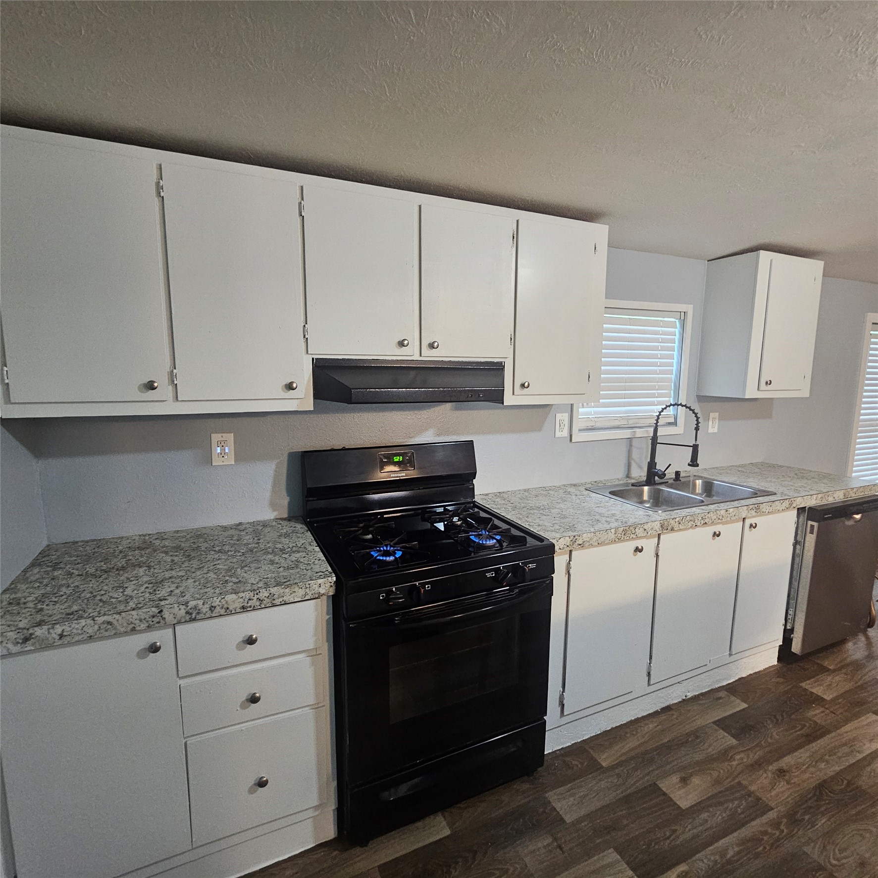 139 Malcom Street Ames, TX 77575 - Photo 5 of 26 a kitchen with granite countertop white cabinets and stainless steel appliances
