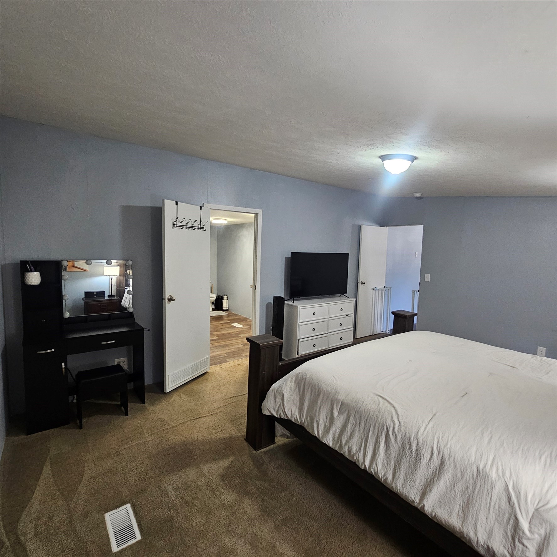 139 Malcom Street Ames, TX 77575 - Photo 8 of 26 a bedroom with a bed and a tv