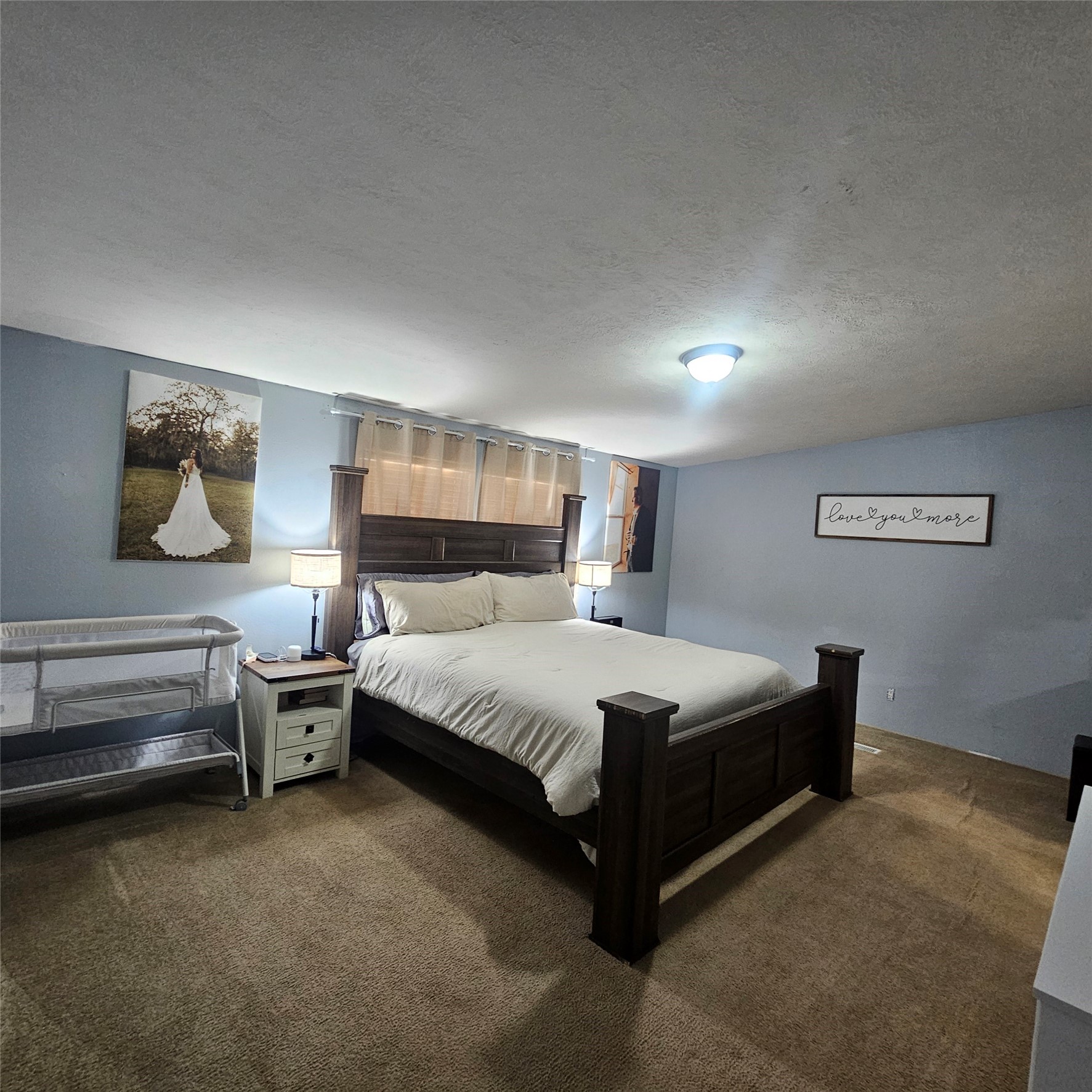 139 Malcom Street Ames, TX 77575 - Photo 9 of 26 a spacious bedroom with a bed and cabinet
