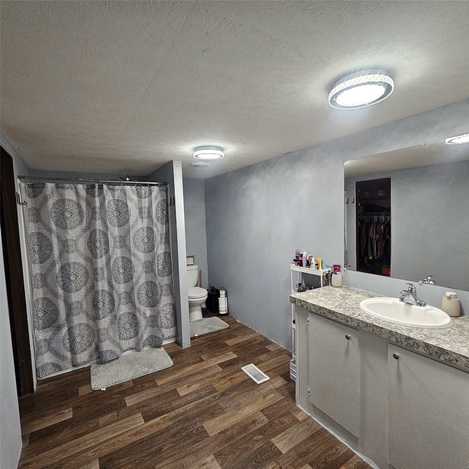 139 Malcom Street Ames, TX 77575 - Photo 10 of 26 a bathroom with a sink and a mirror