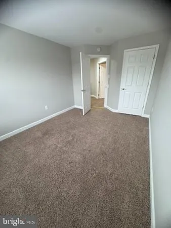 a view of a big room with closet and windows