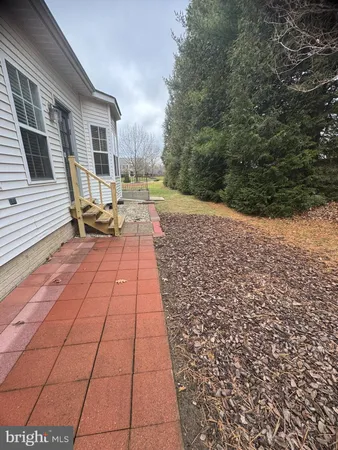a view of a backyard with sitting area
