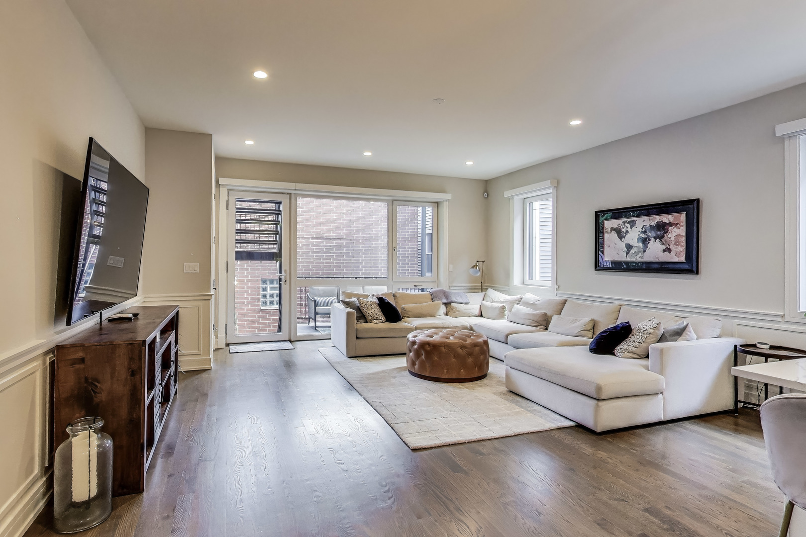 1474 West Ohio Street, Unit 1 Chicago, IL 60642 - Photo 11 of 37 a living room with furniture a flat screen tv and a window
