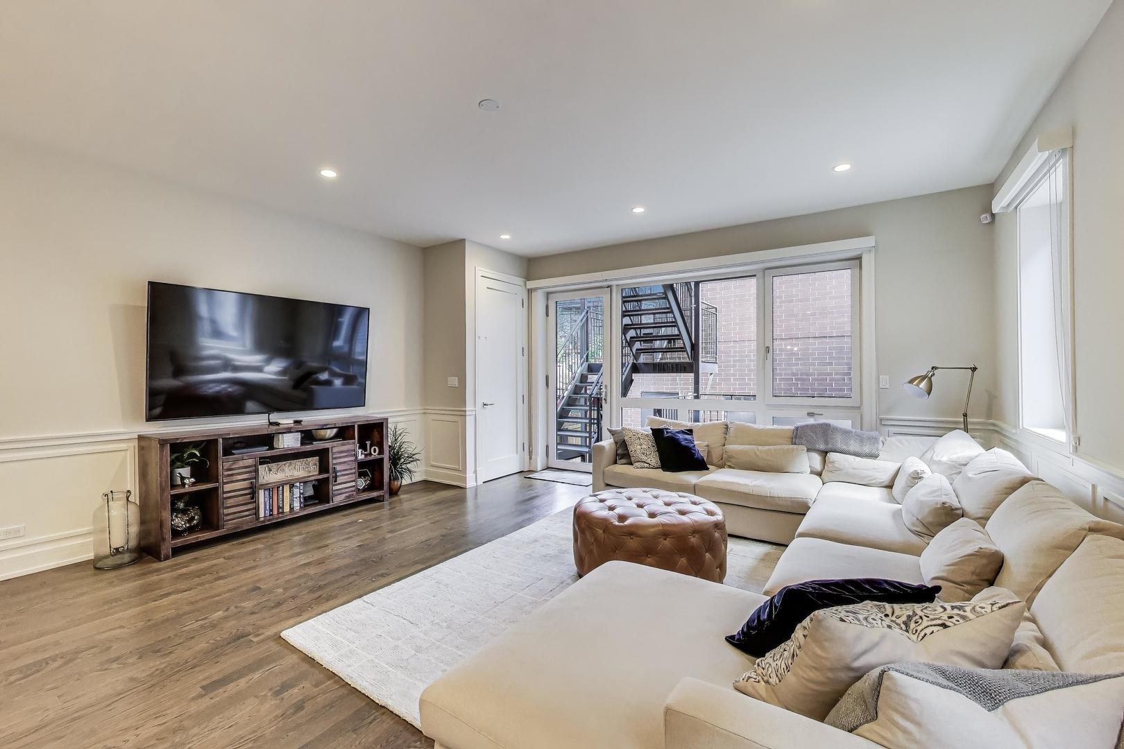 1474 West Ohio Street, Unit 1 Chicago, IL 60642 - Photo 12 of 37 a living room with furniture and a flat screen tv