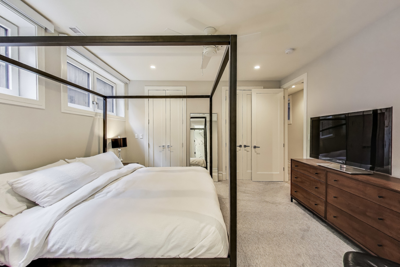 1474 West Ohio Street, Unit 1 Chicago, IL 60642 - Photo 19 of 37 a bedroom with a bed and a flat screen tv