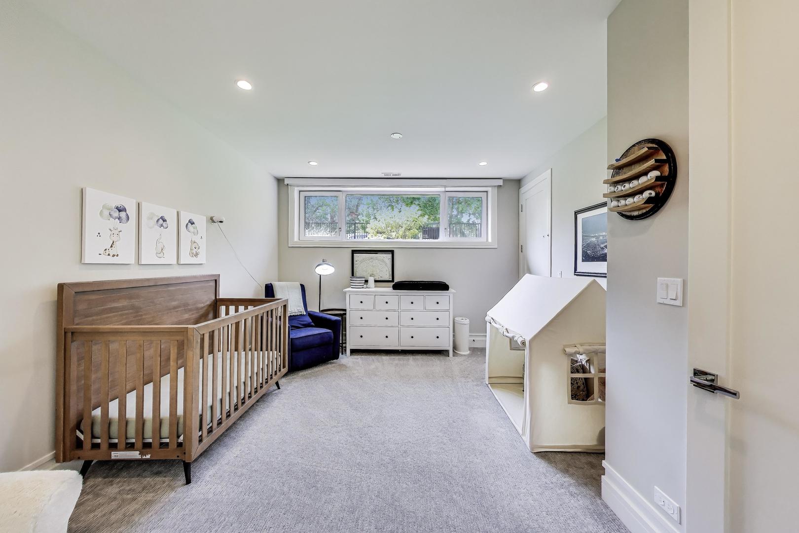 1474 West Ohio Street, Unit 1 Chicago, IL 60642 - Photo 22 of 37 a bedroom with furniture and a window