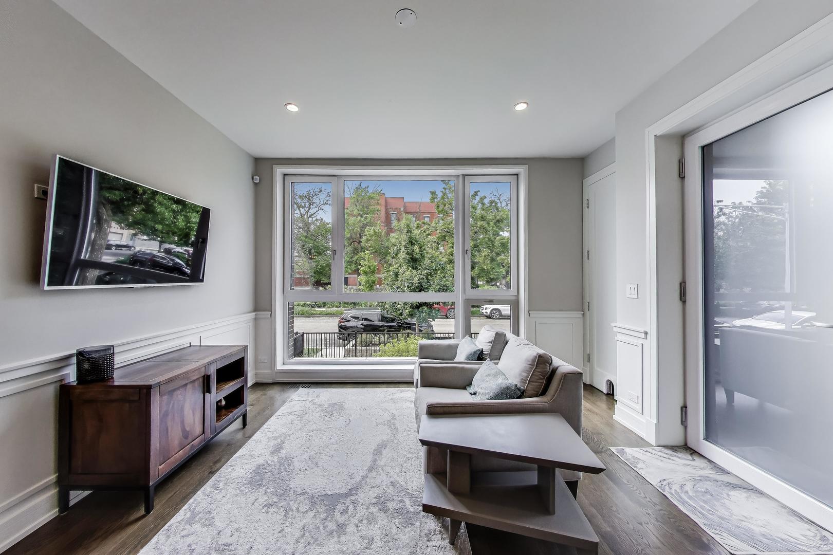 1474 West Ohio Street, Unit 1 Chicago, IL 60642 - Photo 3 of 37 a living room with furniture and a flat screen tv