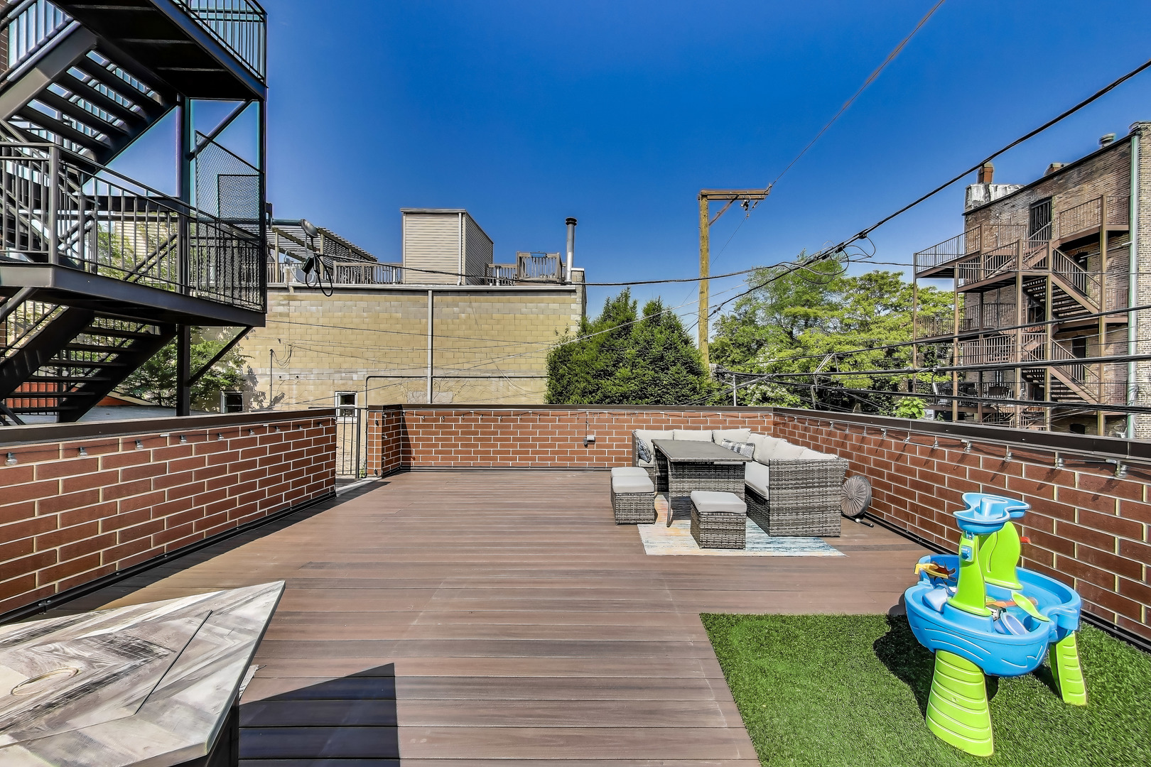 1474 West Ohio Street, Unit 1 Chicago, IL 60642 - Photo 33 of 37 a view of a patio with couches table and chairs and potted plants