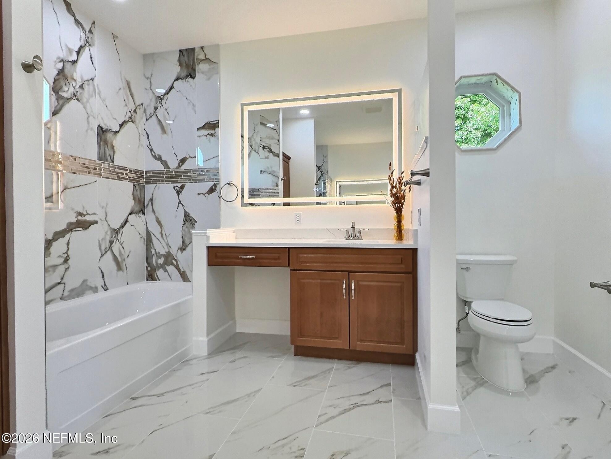 159 Mays Cove Road East Palatka, FL 32131 - Photo 25 of 62 a bathroom with a granite countertop sink a toilet and a bathtub
