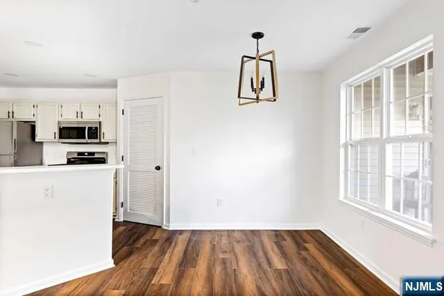 a view of kitchen and wooden floor