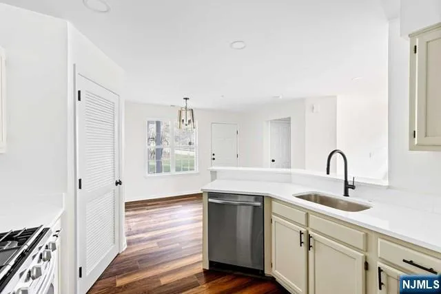 a kitchen with a sink cabinets and a window