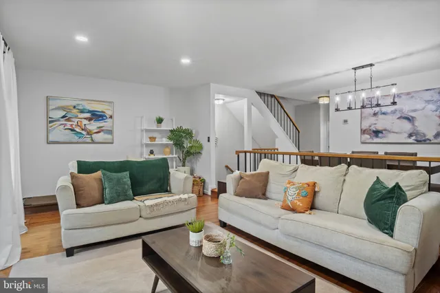 a living room with furniture and wall paintings