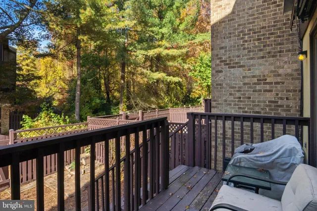 a view of balcony with wooden floor and fence