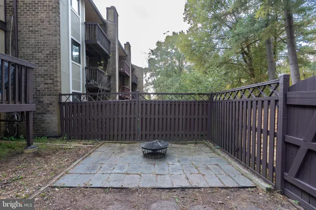a view of a brick house with large windows and a stairs