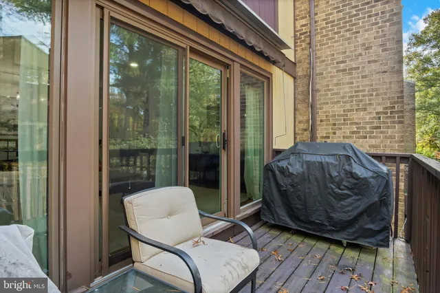 a living room with furniture a rug and a flat screen tv