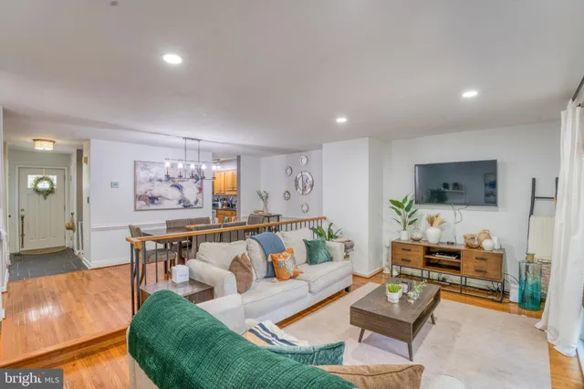a view of a dining room with furniture wooden floor and a chandelier